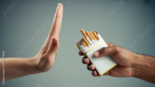 person refusing cigarettes with hand gesture