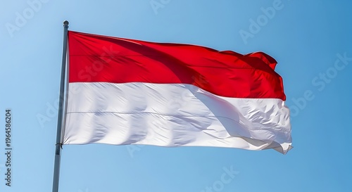 Indonesian red and white flag waving against bright blue sky, natural sunlight, patriotic national identity concept, dynamic motion with strong symbolic meaning