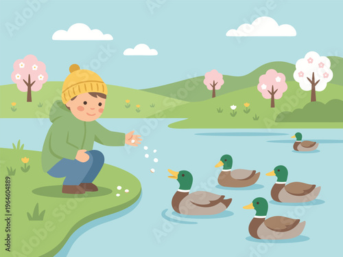 Boy feeding ducks by the lake in spring.