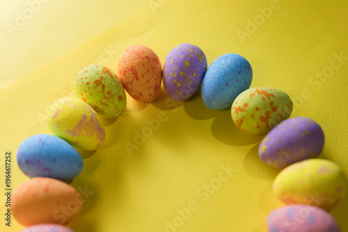 Beautiful decorated Easter eggs on a yellow background and the inscription Easter