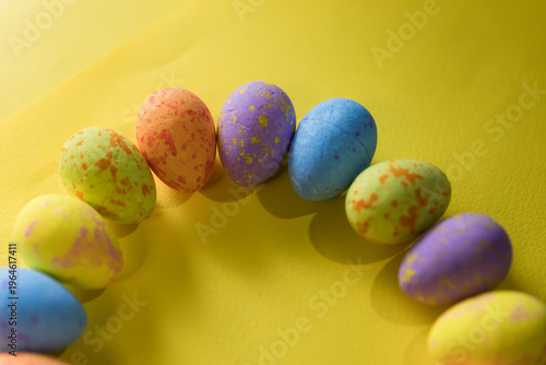 Beautiful decorated Easter eggs on a yellow background and the inscription Easter