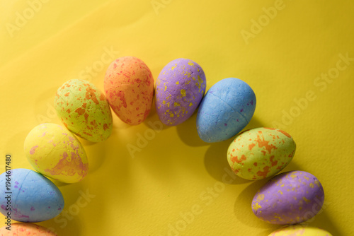 Beautiful decorated Easter eggs on a yellow background and the inscription Easter
