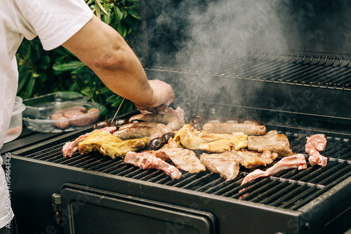 Obraz na plátně Backyard barbecue grilling assorted meats with smoke