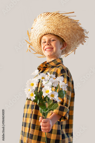 Boy dressed for the June festivals in Brazil with a straw hat and plaid shirt. Isolated.