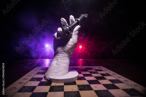 Chess board game concept of business ideas and competition. Chess figures on a dark background with smoke and fog.