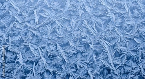 Intricate patterns of frost forming on a cold windowpane
