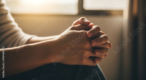A poignant moment of quiet contemplation and introspection, as clasped hands convey deep emotions of hope, prayer, solace, or inner struggle