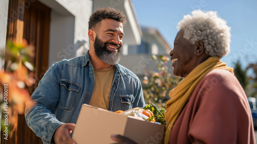Smiling man delivering groceries to elderly woman on a sunny day in a residential neighborhood