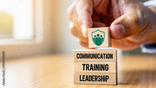 Wooden blocks representing business training concepts, workplace communication leadership, organizational development coaching, corporate responsibility education, compliance management strategy