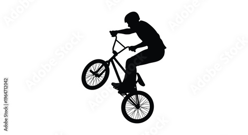 A dynamic silhouette of a cyclist performing a wheelie on a bmx bike showcasing athletic skill and motion silhouette high quality