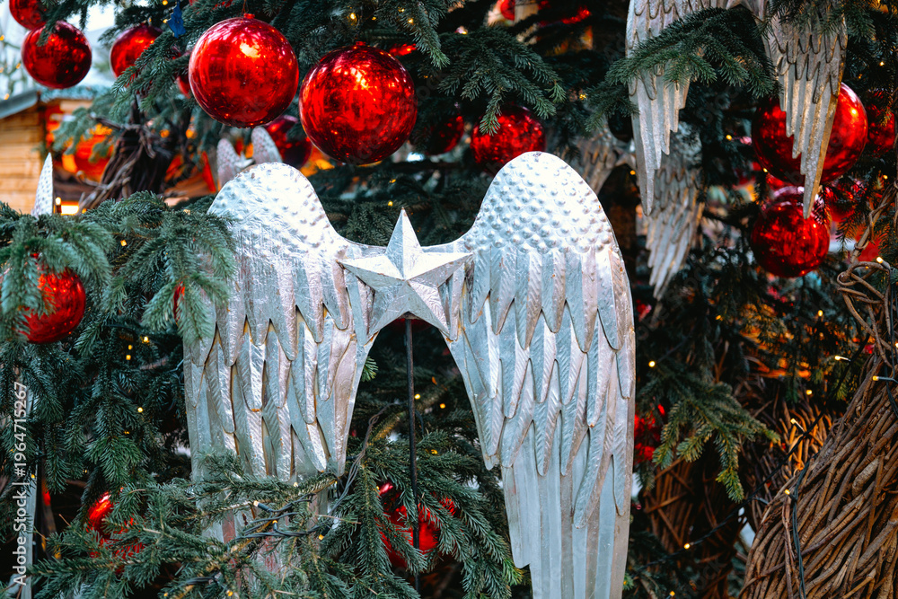Fototapeta premium Christmas tree with angel wings and red ornaments