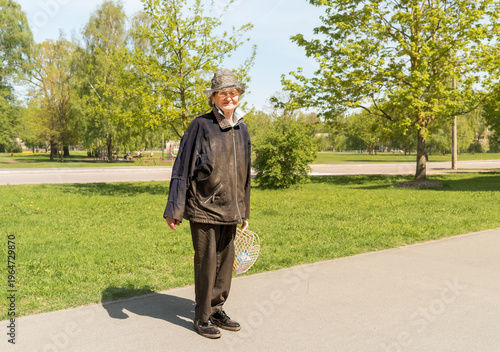 Wallpaper Mural Street portrait of an elderly woman wearing old and worn clothes, showing a sad yet gentle smile.  Torontodigital.ca