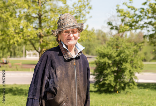 Wallpaper Mural Street portrait of an elderly woman wearing old and worn clothes, showing a sad yet gentle smile. Expressive face with deep wrinkles and emotional expression. Torontodigital.ca