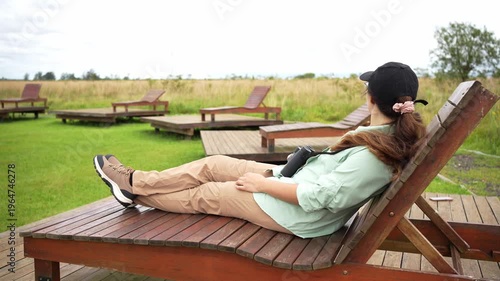 Woman relaxing and birdwatching in a natural park