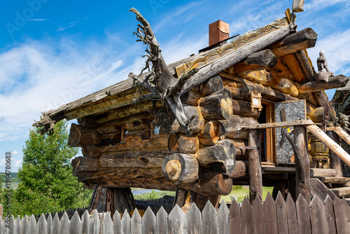 The house of Baba Yaga, the fairytale witch. A log house from a fairytale set in a green landscape.