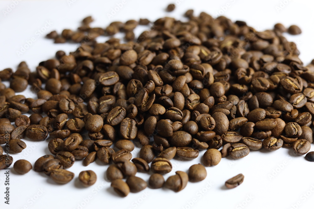 Fototapeta premium Gourmet Civet coffee beans scattered on white background, selective focus with bokeh.