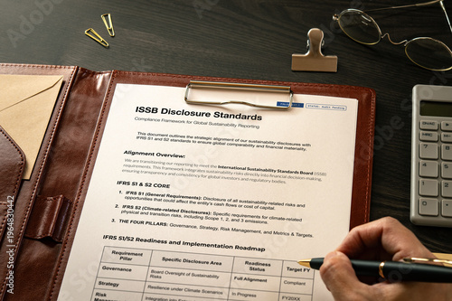 Professional visualization of ISSB Disclosure Standards on mock with clips, calculator. Financial and economic strategic background.