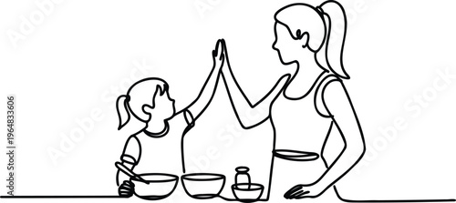 A woman and a child high five each other while cooking in the kitchen with bowls and a blender