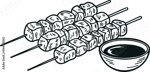 Skewers of meat and a bowl of sauce for barbecue and grilling outdoors on a summer day with friends and family