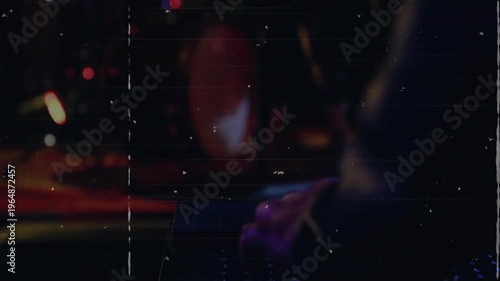 Hands cueing synth riff to start, camera pulling back showing singer, band performing under grain