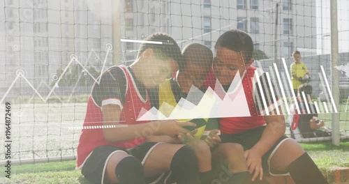 3 boys by goal net raising phone then huddling and analyzing sports charts overlaying phone screen