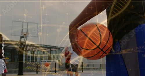 Holding right arm blue jersey adjusting grip at court post dribble hoop, orangeball DNA, copy space