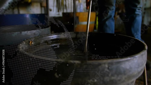 Blacksmith lowering hot horseshoe into quench bucket, causing bubbles, steam, splashes and cooling