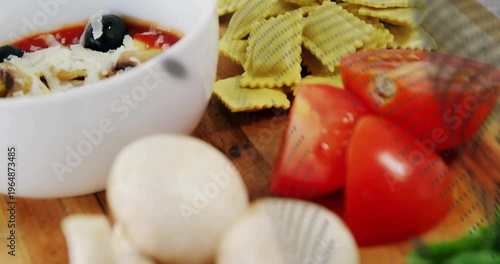 Food on board reacting to dotted sweep, camera panning, focusing mushrooms and tomatoes for food ad