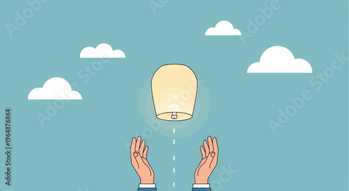 Hands releasing a flying lantern.
