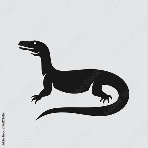 Black silhouette of a monitor lizard standing tall and alert