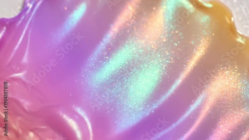 A swirling purple and pink iridescent liquid with a shiny, reflective surface