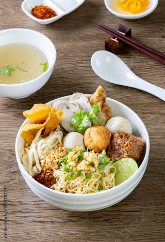 dry Chinese yellow noodles with bean sprout topping pork meatball