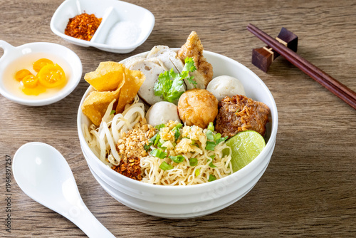 dry Chinese yellow noodles with bean sprout topping pork meatball