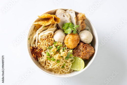 dry Chinese yellow noodles with bean sprout topping pork meatball