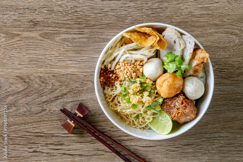 dry Chinese yellow noodles with bean sprout topping pork meatball