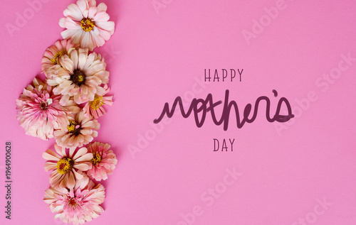 Happy Mother's Day pink background with zinnia flowers flat lay for holiday greeting banner in celebration of mom.