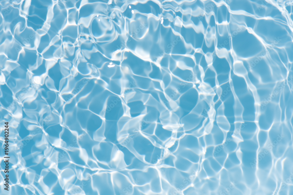 Fototapeta premium Blue water with ripples on the surface. Defocus blurred transparent blue colored clear calm water surface texture with splashes and bubbles. Water waves with shining pattern texture background.