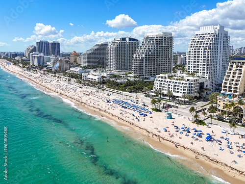 Spring breakers enjoying a sunny beach day at Fort Lauderdale Beach in Broward County, Florida.