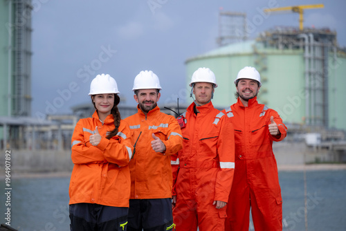 Engineering team showing thumbs up at refinery plant
