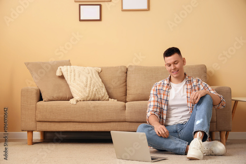 Young man watching movie on...