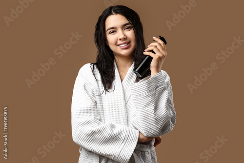 Young woman with hair spray...