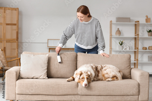 Young woman with lint rolle...