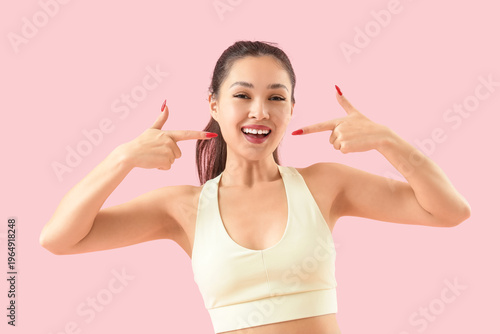 Sporty Asian woman pointing...