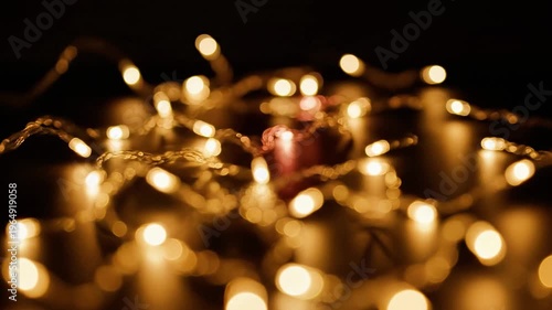 A blurry nighttime scene with golden lights on a dark background