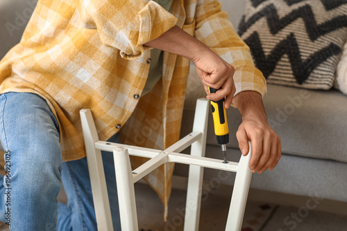 Young man with screwdriver ...