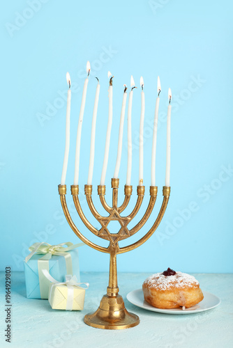 Menorah with burning candle...