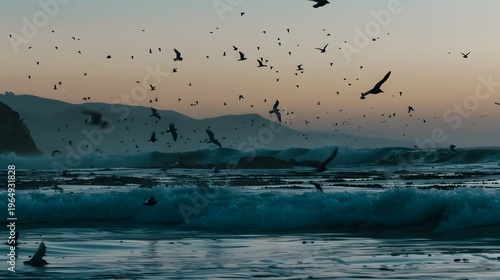 A flock of birds flying over the ocean at sunrise
