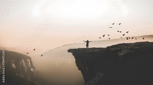 A person standing at the edge of a cliff arms stret