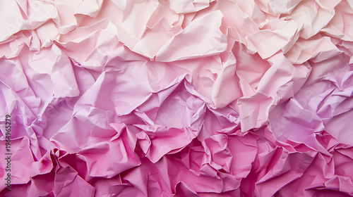 Crumpled paper in shades of pink creates textured and visually appealing background, evoking sense of creativity and artistic expression