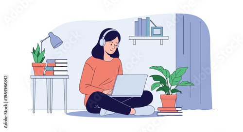 Young woman sitting cross-legged on the floor with headphones on her head working on a laptop in a cozy home environment.